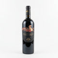 Wine bottle with decorative Eremo San Quirico label on a white background