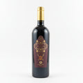A bottle of wine with a label that features intricate floral designs and the text 'Compagnia Siciliana Real Academia'.