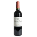 A bottle of Cháteau Senejac Haut-Medoc 2020 wine positioned in front of a couch with a label that includes the name of the wine and the year.