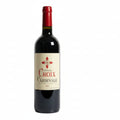 A bottle of Chéteau Croix Cardinale Saint-Emilion Grand Cru wine with a red seal and a white label featuring the name of the chéteau and the wine type.