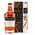 A bottle of Midleton Very Rare Chestnut Edition Dark Wood Collection Irish Whiskey stands in front of its illustrated black and white box on a warm beige background.